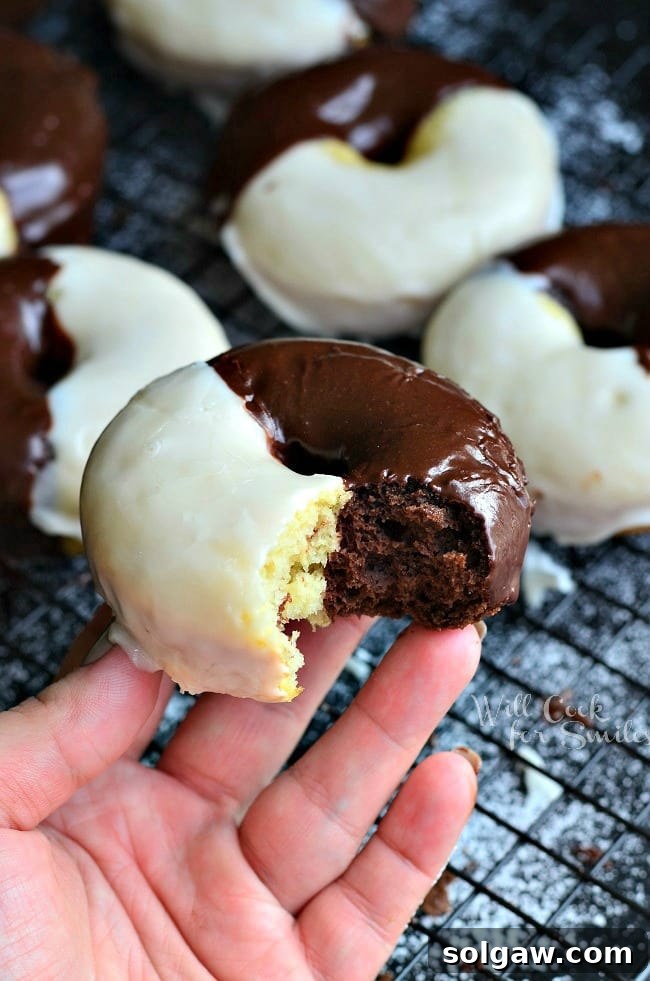 Freshly baked Black and White Glazed Donuts cooling on a rack, ready for glazing