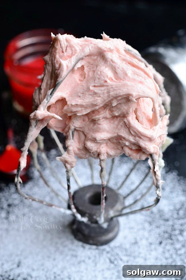 Detailed view of the luscious Strawberry Buttercream Frosting, showcasing its rich texture and natural color.