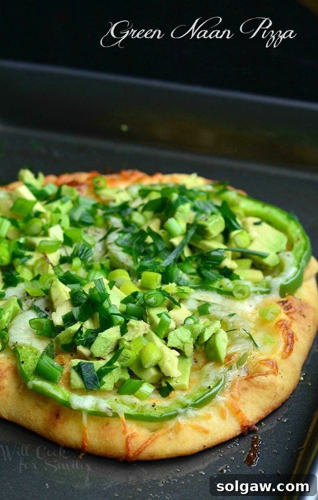 Green Naan Pizza with avocado, green peppers and green onions on top, showcasing its vibrant colors.