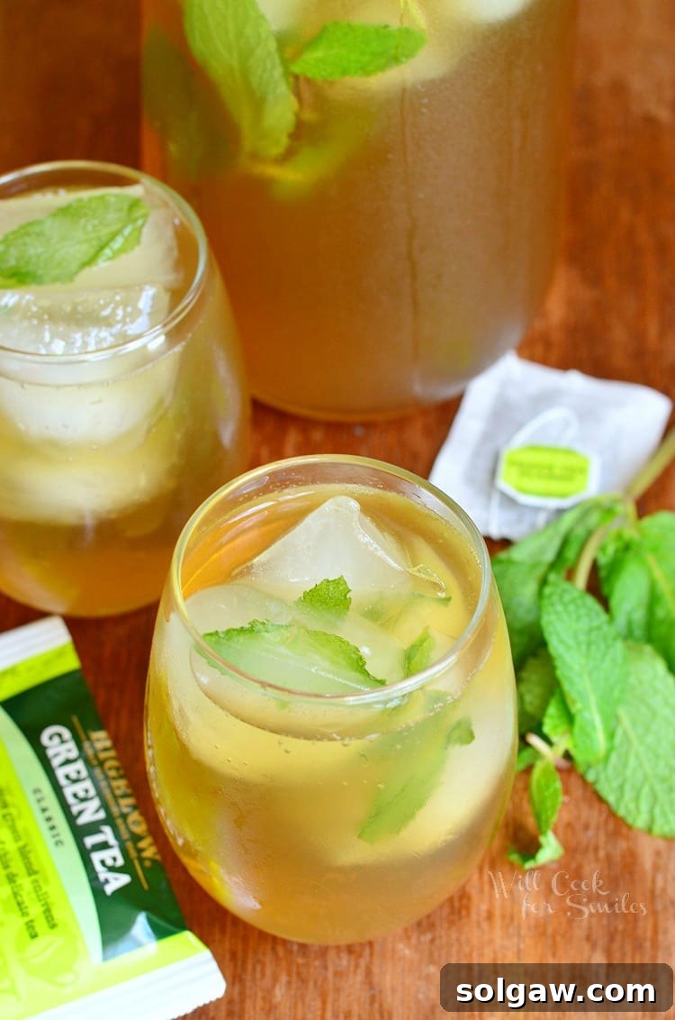 Top view of Honey Mint Green Iced Tea in a glass, garnished with fresh mint leaves