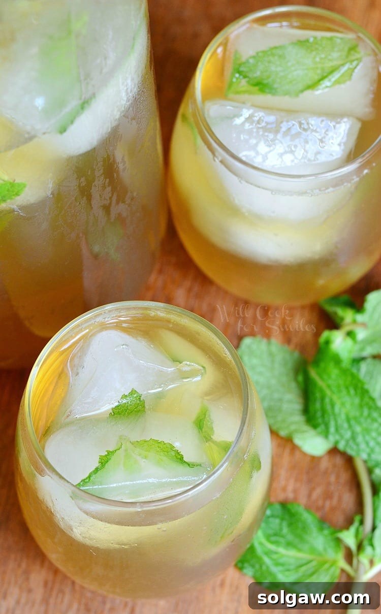 Top view of Honey Mint Green Iced Tea in a glass, with fresh mint leaves and ice