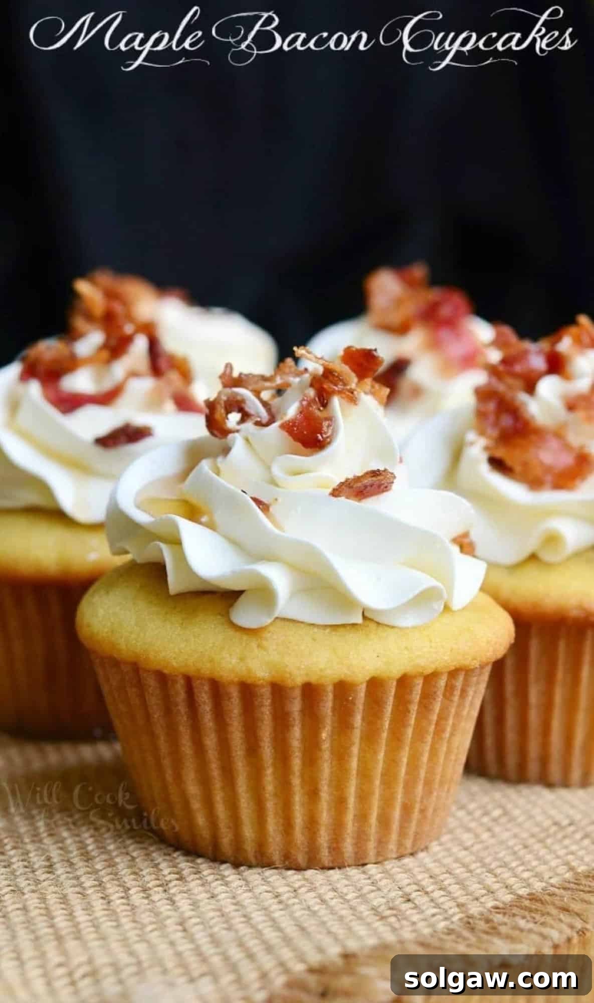 Delicious maple bacon yellow cake cupcakes topped with beautifully swirled maple buttercream frosting, crunchy bacon bits, and a glistening maple syrup drizzle.
