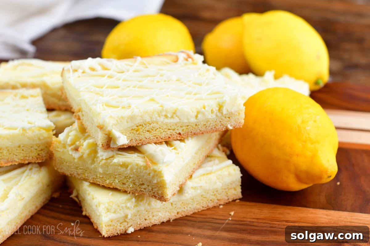 Beautifully arranged lemon cheesecake cookie bars on a rustic wooden surface, surrounded by fresh, vibrant lemons, highlighting their zesty appeal and perfect for a spring dessert.