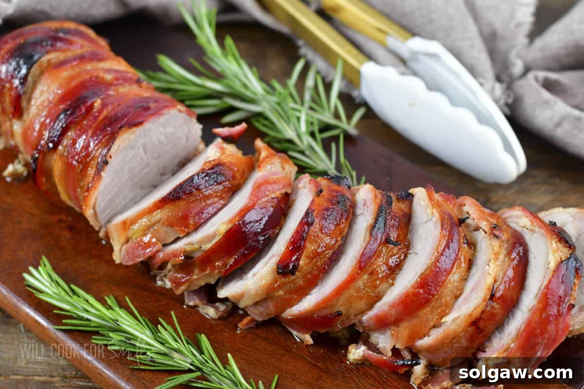 Bacon Wrapped Pork Perfection 10 Stacked slices of Bacon Wrapped Pork Tenderloin showcasing the crispy bacon and juicy interior.