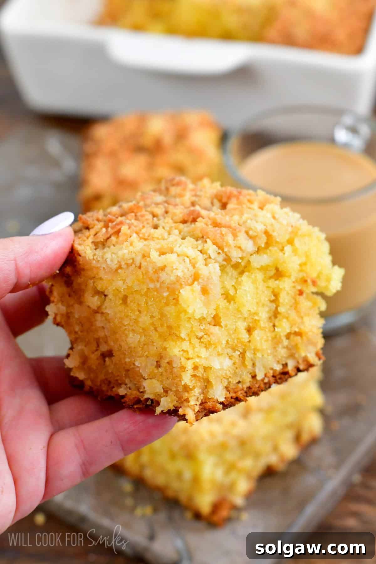 Holding a slice of coconut coffee cake in my hand.